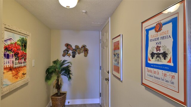 corridor featuring a textured ceiling