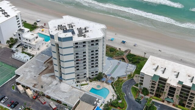 birds eye view of property with a beach view and a water view