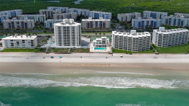 birds eye view of property featuring a beach view and a water view