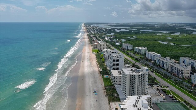 drone / aerial view with a water view and a view of the beach