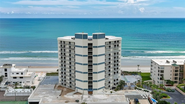 birds eye view of property featuring a view of the beach and a water view