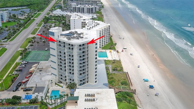 drone / aerial view featuring a water view and a view of the beach