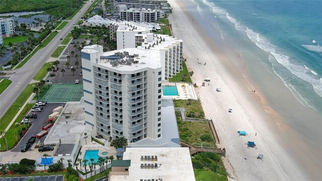 birds eye view of property featuring a beach view and a water view