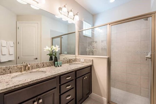 bathroom featuring vanity and a shower with shower door