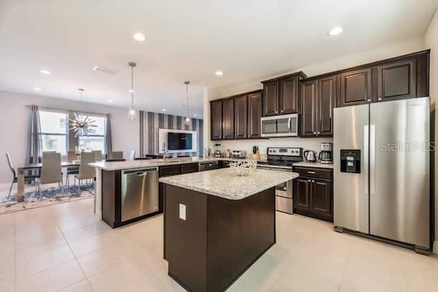 kitchen with a kitchen island, decorative light fixtures, dark brown cabinets, appliances with stainless steel finishes, and kitchen peninsula