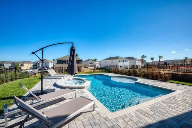 view of pool featuring an in ground hot tub and a patio area