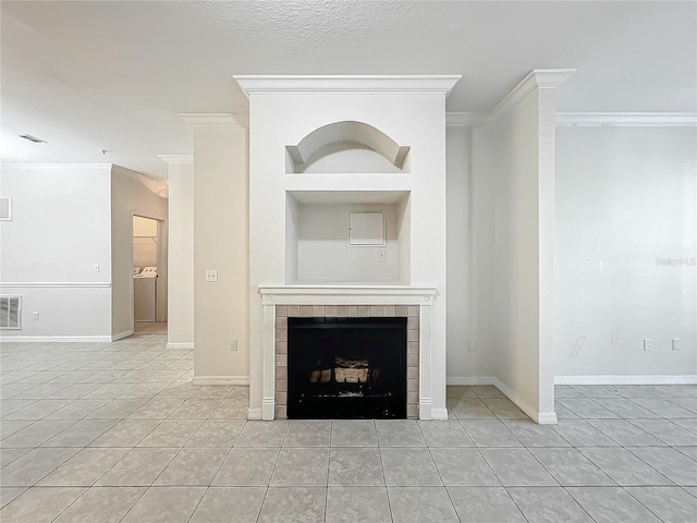 unfurnished living room with a fireplace, a textured ceiling, crown molding, and light tile patterned flooring