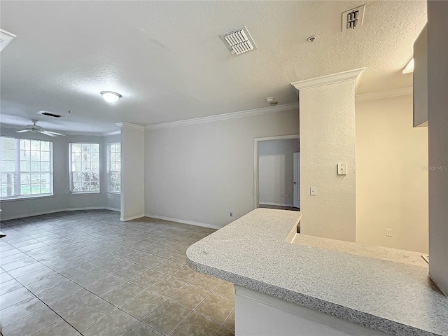 interior space featuring a textured ceiling, ceiling fan, ornamental molding, and light tile patterned floors