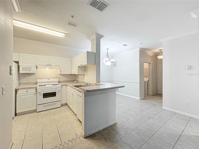 kitchen with white appliances, sink, kitchen peninsula, light tile patterned flooring, and ornamental molding