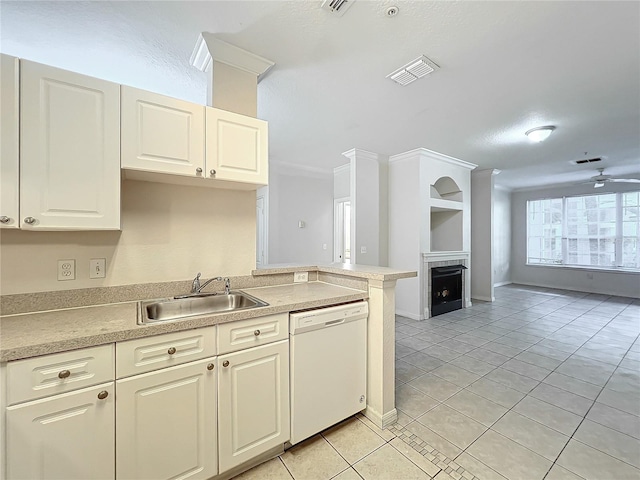 kitchen featuring light tile patterned floors, dishwasher, sink, kitchen peninsula, and ceiling fan