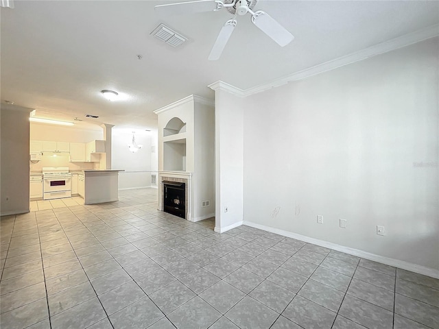 unfurnished living room with built in shelves, ceiling fan, light tile patterned floors, and ornamental molding