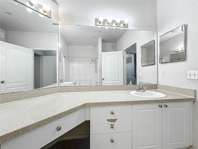 bathroom with vanity and walk in shower