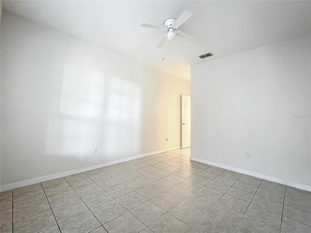 empty room featuring ceiling fan and light tile patterned floors