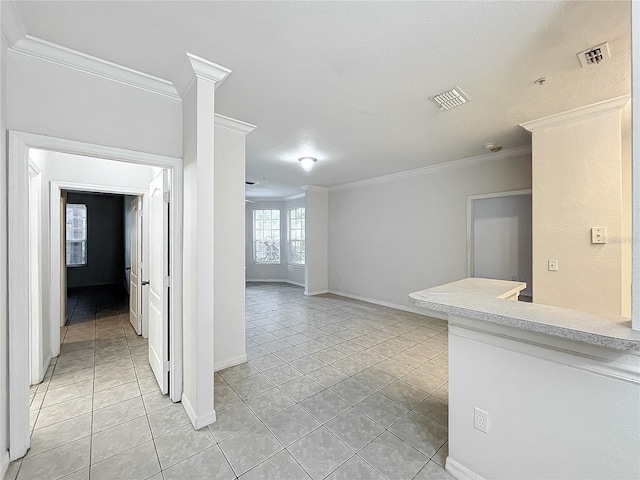 tiled spare room featuring ornamental molding