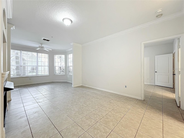 interior space featuring ornamental molding, a textured ceiling, light tile patterned floors, and ceiling fan