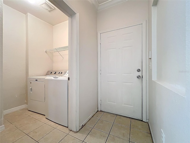 laundry room featuring light tile patterned floors and washer and clothes dryer