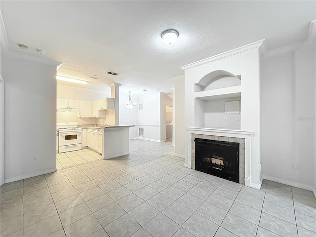 kitchen featuring white range with gas cooktop, ornamental molding, kitchen peninsula, and light tile patterned floors