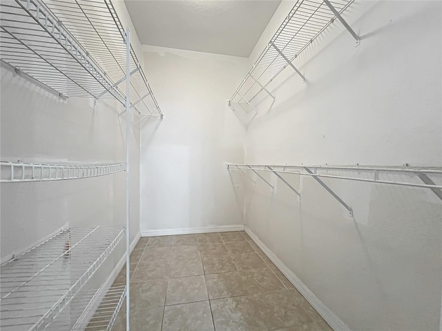 walk in closet featuring tile patterned flooring