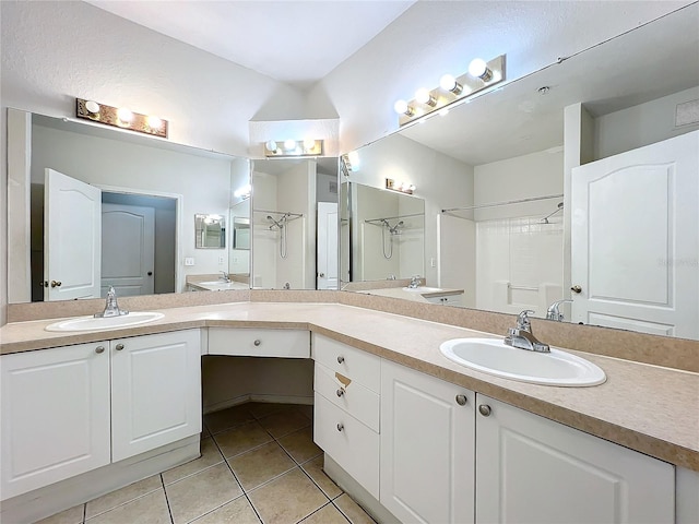 bathroom featuring tile patterned flooring, vanity, and walk in shower