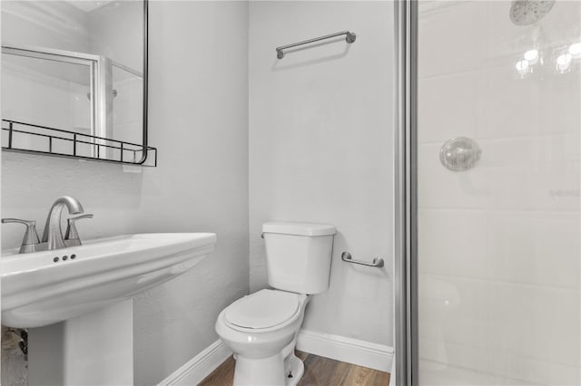 bathroom with toilet, wood-type flooring, and walk in shower