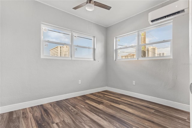 spare room with ceiling fan, an AC wall unit, and dark hardwood / wood-style flooring