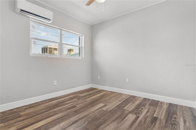 spare room featuring ceiling fan, wood-type flooring, and a wall mounted air conditioner