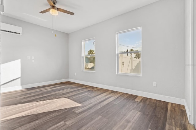 empty room with ceiling fan, a wall unit AC, and dark hardwood / wood-style flooring