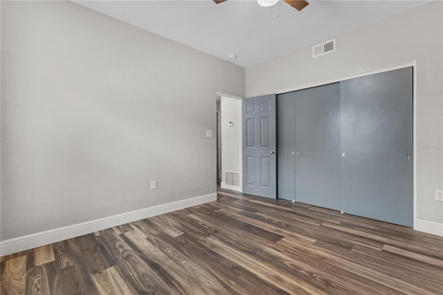 unfurnished bedroom featuring a closet, ceiling fan, and dark hardwood / wood-style floors