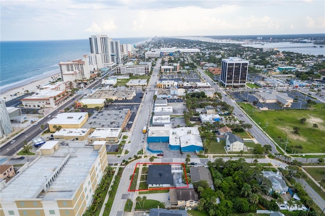 birds eye view of property featuring a view of the beach and a water view