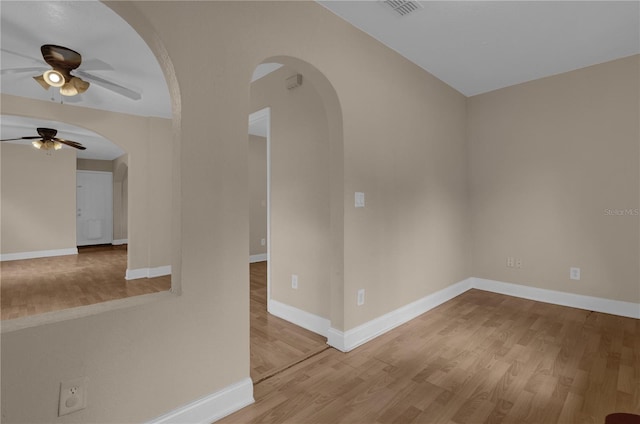 spare room featuring wood-type flooring and ceiling fan