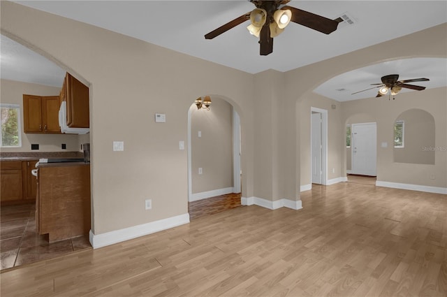 living room with ceiling fan and light hardwood / wood-style floors