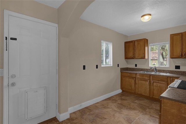 kitchen featuring sink and light tile patterned flooring