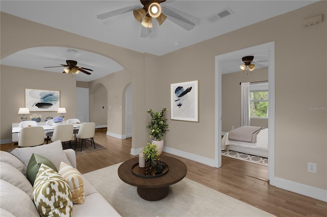 living room with ceiling fan and hardwood / wood-style flooring