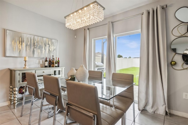 tiled dining space with a notable chandelier