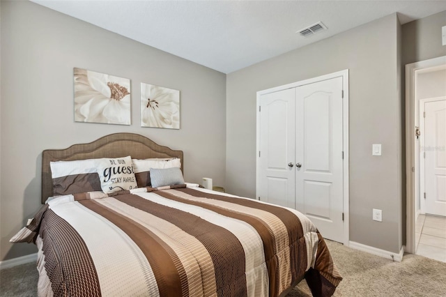 bedroom featuring light colored carpet and a closet