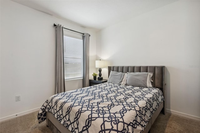 bedroom with dark colored carpet