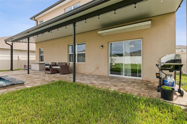 back of house with an outdoor hangout area, a yard, and a patio area