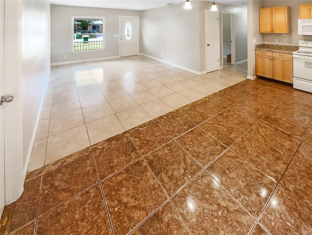 interior space with light tile patterned floors and baseboards