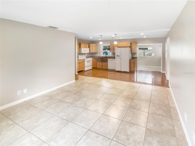 kitchen featuring light tile patterned floors, baseboards, white appliances, and recessed lighting