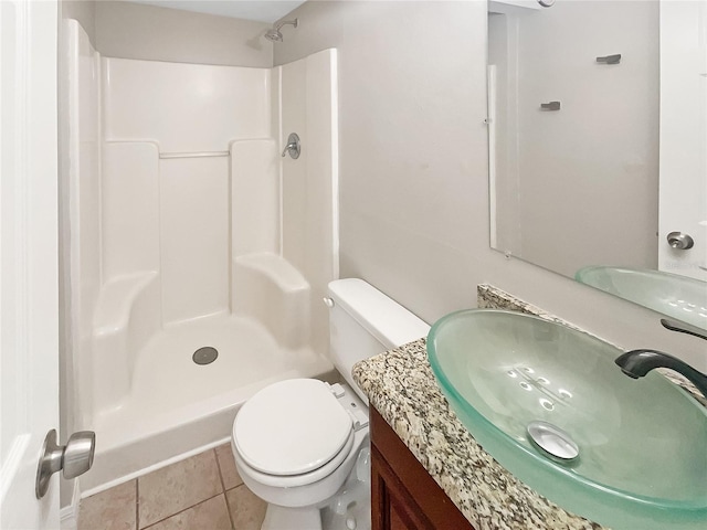 full bath featuring vanity, tile patterned floors, toilet, and walk in shower