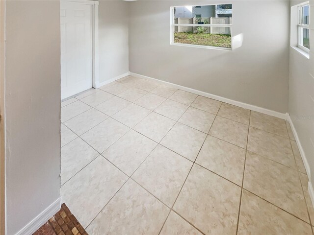 tiled empty room with a wealth of natural light