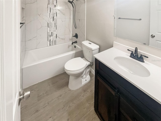 full bath featuring washtub / shower combination, toilet, wood finished floors, and vanity