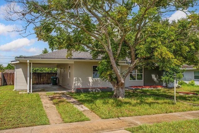 view of front of property with a front lawn and a carport