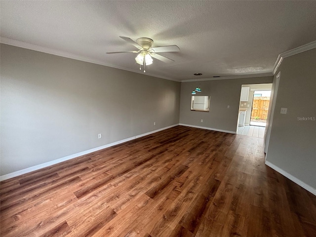 spare room with a textured ceiling, crown molding, ceiling fan, and wood-type flooring