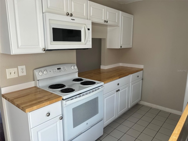 kitchen featuring white appliances, wood counters, white cabinetry, and light tile patterned flooring