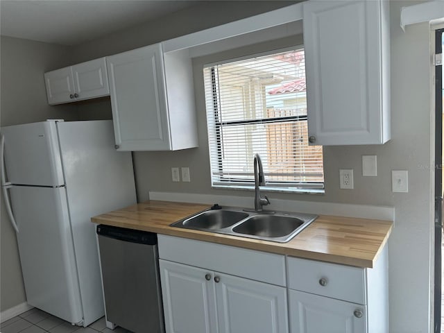 kitchen featuring white fridge, wood counters, sink, and stainless steel dishwasher