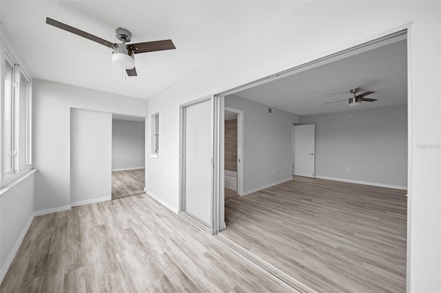 unfurnished room featuring light wood-type flooring and ceiling fan