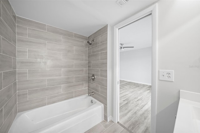 bathroom featuring tiled shower / bath and wood-type flooring