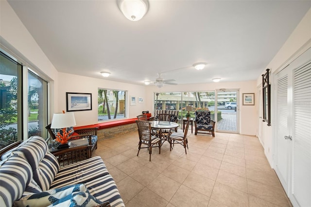 dining space with ceiling fan, light tile patterned flooring, and a healthy amount of sunlight