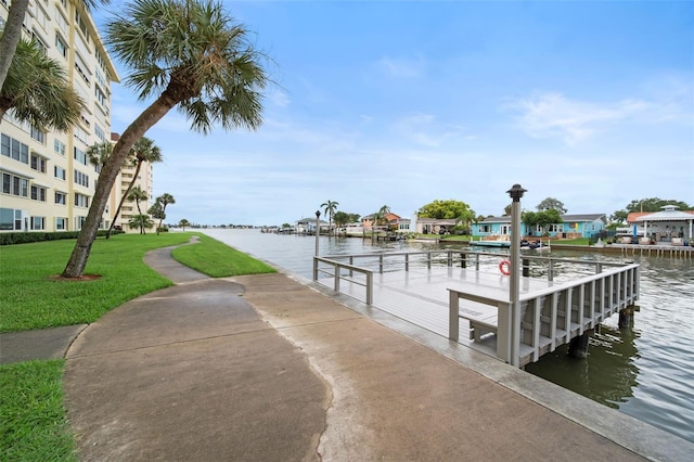 view of dock featuring a yard and a water view